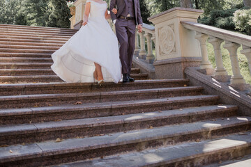 groom with bride on stairs near the building