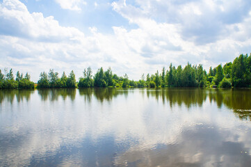 Fototapeta premium Summer lake shore with sky reflection