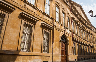 Street view of colorful building facade with ornate windows and door in town of Casale Monferrato, Piedmont, Italy