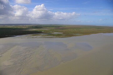 A view of a flat coastal landscape in Normandy, France.
