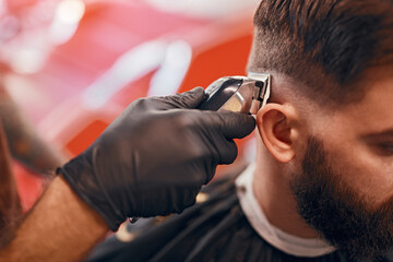 Bearded man during haircut procedure in barbershop