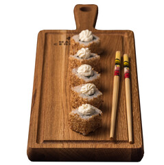 Sushi rolls on a wooden sideboard isolated on white background. Japanese food concept.
