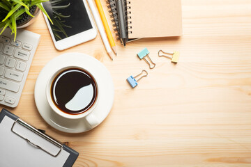 Workplace of office desk wooden table with laptop, and smartphone and equipment other office supplies with copy space, flat lay