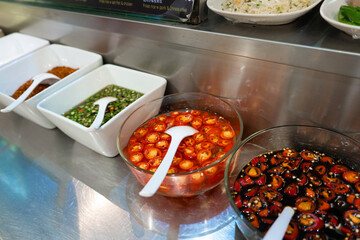 Street food market in Asia. Bowls with hot sauces of various types.