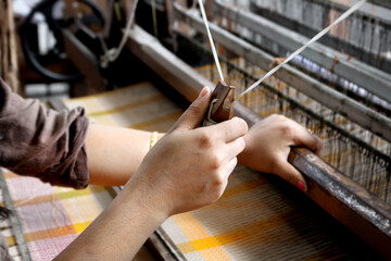 Handloom weaver in India working in her loom