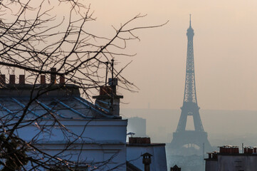Eiffel Tower viewed at dusk from the hill at Montmartre , Paris France.