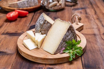 Cheese tomme de montagne or tomme de savoie made from cow milk in French Alps.
