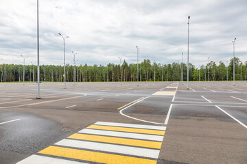 Empty free outdoor parking near the shopping mall on a cloudy summer day