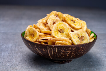Healthy snack, crispy dehydrated unsugared banana chips in bowl