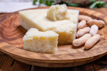 Pieces of matured pecorino romano italian cheese made from sheep milk in Lazio, Sardinia or Tuscany