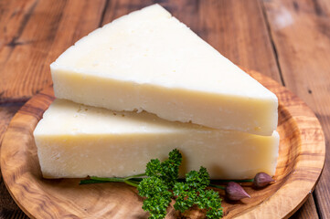 Pieces of matured pecorino romano italian cheese made from sheep milk in Lazio, Sardinia or Tuscany