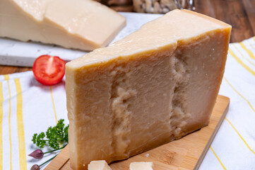 Big wedges of parmigiano-reggiano parmesan hard Italian cheese made from cow milk or Grana Padano