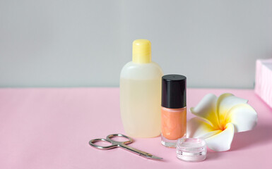 nail polish scissors rub for manicure and a flower on a pink gray background, nail care manikure and pedicure at home or in a spa salon procedures