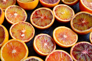 Blood oranges background, halved fruits