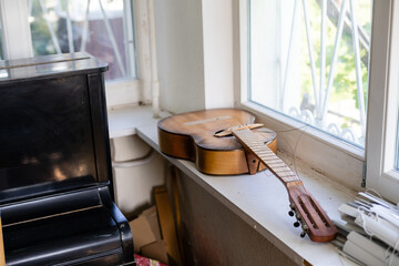 Old dusty guitar in an old house. Spruce dreadnought acoustic guitar. Guitar on background.