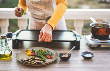 Young woman chef cooking outdoor for webinar masterclass lesson at home - Food concept - Main focus on close up hand
