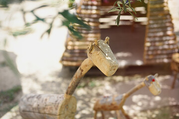 Handmade wooden animals for children to play in the park.