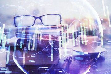 Business theme hologram with glasses on the table background. Concept of search. Double exposure.