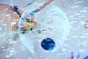 Fototapeta premium Double exposure of Man writing in notepad with business icons on background.