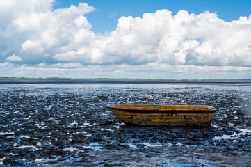 a single boat in the wadden sea at ebbe