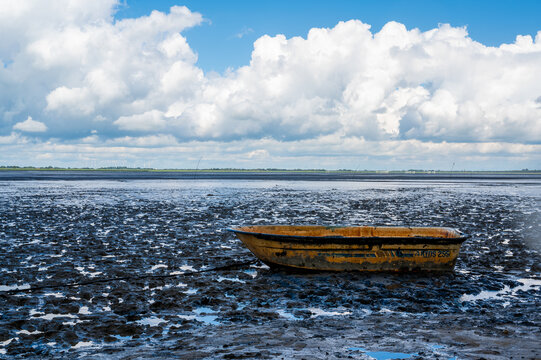 a single boat in the wadden sea at ebbe
