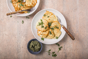 Vegetarian zucchini fritters or pancakes  with pesto  and cilantro. Vegetable pancakes