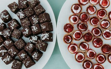 chocolate cakes and strawberry pastries on a table