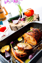 Lecere roll roast with vegetables and herbs.