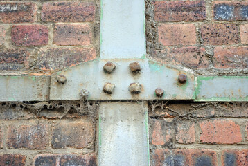 Close Up of Bolted Metal Bracing on Old Brick Wall of Industrial Building