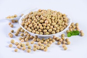 Yellow-green Taiwanese organic non-GMO soybeans, soy beans in a container isolated on white backgorund, close up, clipping path.