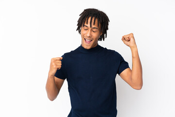 Young african american man isolated on white background celebrating a victory