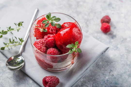 Summer raspberry sorbet with fresh raspberries, selective focus image