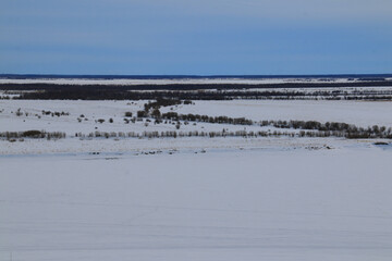 Landscapes of the Khanty-Mansiysk Autonomous Okrug - Ugra. Snow, hills and plains, coniferous forest and frozen rivers