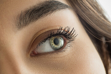 Fototapeta premium Close up of face, eyes of beautiful caucasian young woman, clear look. Human emotions, facial expression, cosmetology, body and skin care concept. Hopeful, dreamful look, sight. Psychology, fashion.