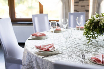 Festive table setting with wine glasses, and fresh flowers