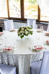 Festive table setting with wine glasses, and fresh flowers