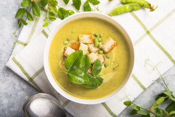 Plate of summer delicious pea  soup with green peas. Top view