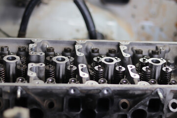 The mechanic is checking the engine.