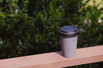 Obraz premium Reusable eco-friendly bamboo cup with lid, copy space.