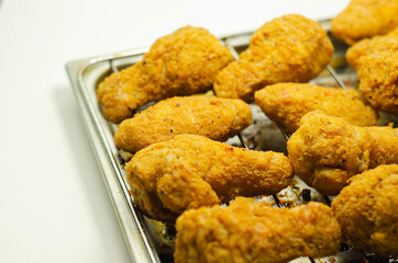 Southern crispy battered fried chicken wings, deep-fried chicken wings on the metal tray