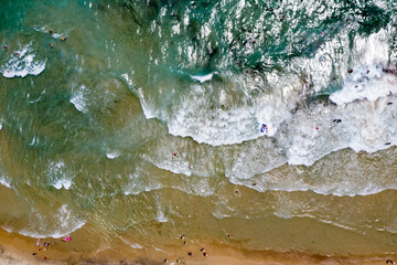 Thassos seaside beach with turquoise water and big waves aerial view.