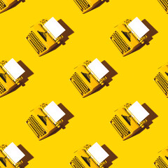 Yellow bright typewriter on a yellow background. Creativity concept
