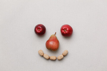 face made of fruits on a gray background