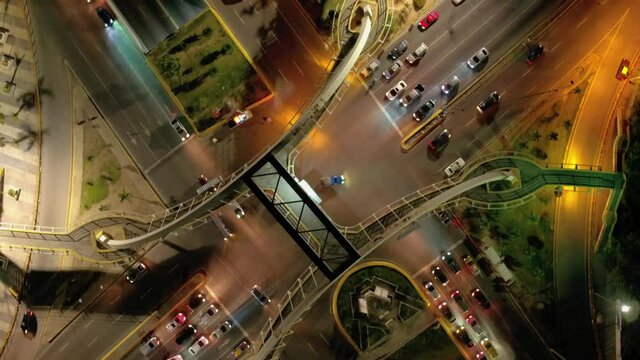 Spiral shot on the pedestrian bridge of Avenida Maximo Gomez, many cars and spectacular lights in Santo Domingo
