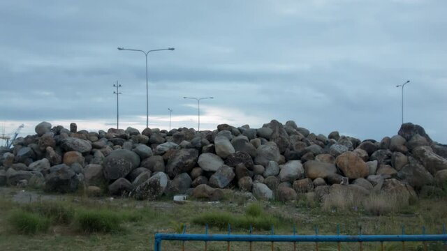 A pile of rocks on a grassy field at the Cadiz City New Port, Philippines.