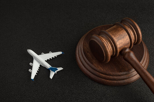 Wooden judges gavel and toy plane. Aviation Law. Lawsuit with the airline