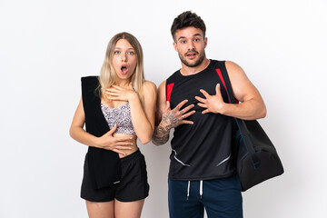 Young sport couple isolated on white background surprised and shocked while looking right