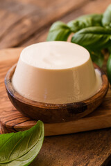 Ricotta cheese in rustic wooden bowl.
