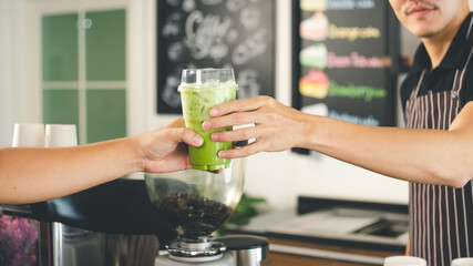 Barista is making drinks in the coffee shop.