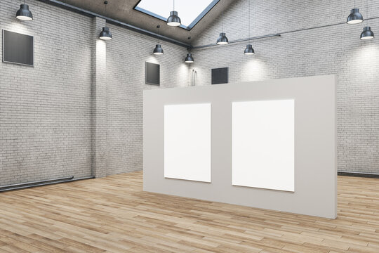 Modern brick warehouse interior with two empty posters on wall